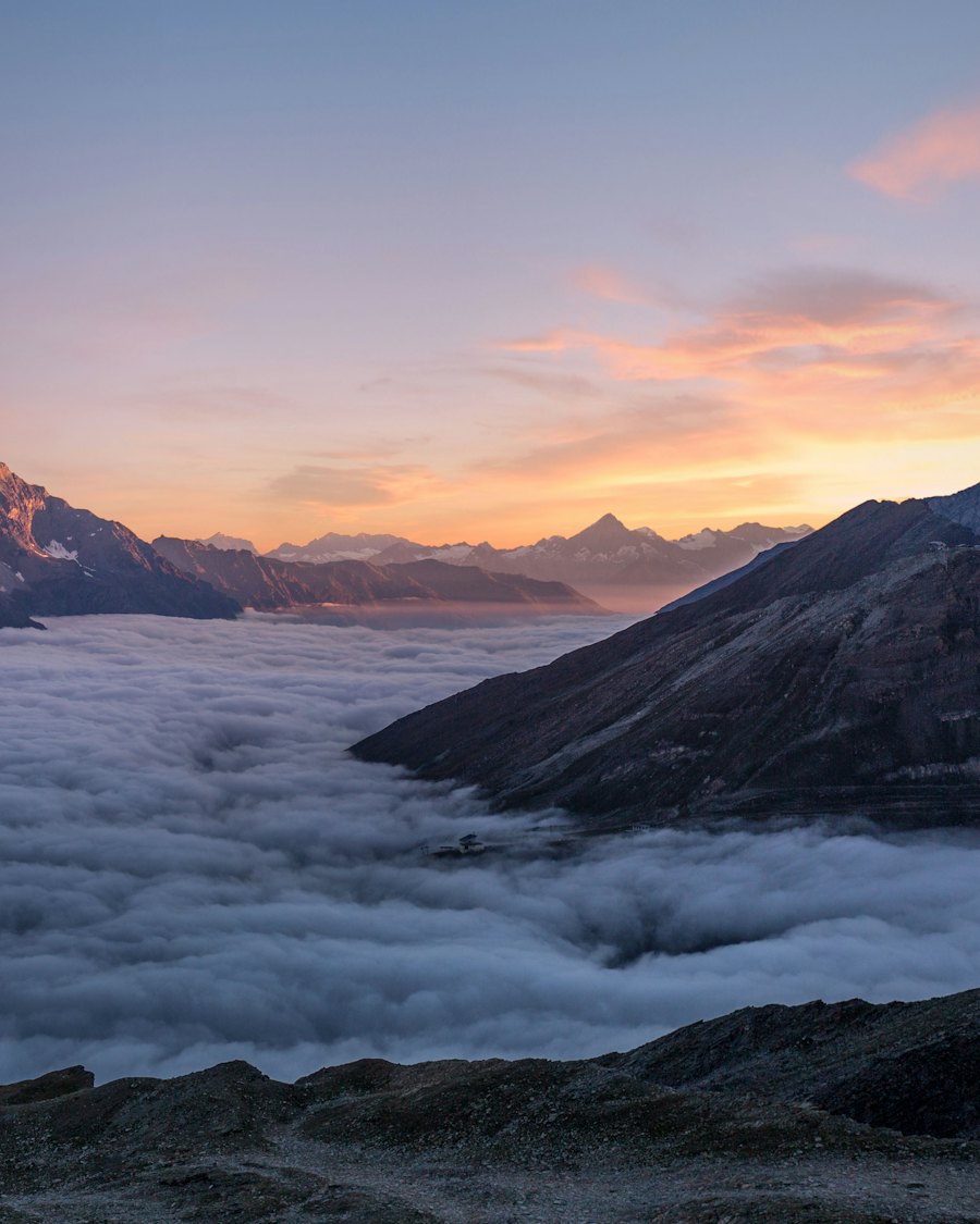 Mountains above the clouds at sunrise.
